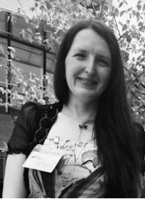 Tanja, a 40 something white woman, is pictured in the courtyard of the British Library at the Yoto Carnegie Medals ceremony in June 2022 where she represented Northern Ireland on the judging panel.